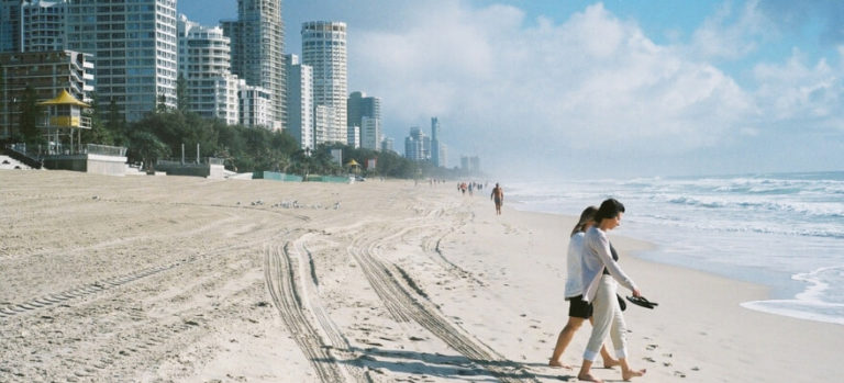 Two people walking on Gold Coast beach